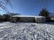 Backyard view of house exterior with snow covered ground at 975 Stonegate Rd, Greenwood, IN 46142