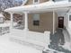 Front porch with white columns and snow covered walkway at 1126 W 28Th St, Indianapolis, IN 46208