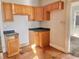 Small kitchen with light oak cabinets and dark countertops at 1218 N Ewing St, Indianapolis, IN 46201