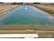 Scenic view of a pond with a fountain, surrounded by an open field at 1350 Foxtail Ln, Greenwood, IN 46143