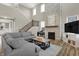 Living room with sectional sofa, stone fireplace, and hardwood floors at 14115 Larson Dr, Carmel, IN 46033