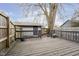Wooden deck with gray railings overlooks a fenced backyard with shed at 1421 E New York St, Indianapolis, IN 46201