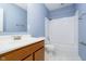 Clean bathroom with shower/tub combo, wood vanity, and tiled floor at 1421 E New York St, Indianapolis, IN 46201