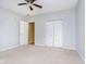 Bright bedroom featuring ceiling fan, double closet, and additional access door at 1421 E New York St, Indianapolis, IN 46201