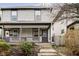 Two-story home with gray siding, front porch, and landscaping at 1421 E New York St, Indianapolis, IN 46201