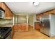 Modern kitchen with stainless steel appliances and wood cabinets at 1421 E New York St, Indianapolis, IN 46201