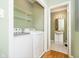 Laundry room with washer, dryer, and additional shelving at 1421 E New York St, Indianapolis, IN 46201