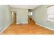 Hardwood floors and staircase in a green-walled living room at 1421 E New York St, Indianapolis, IN 46201