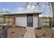 Small storage shed with dark brown door in backyard at 1421 E New York St, Indianapolis, IN 46201