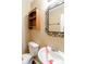 Small bathroom with white toilet and sink, and an ornate mirror at 2716 Redland Ln, Indianapolis, IN 46217