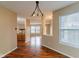 Open concept dining area with hardwood floors and view into the living room and kitchen at 2716 Redland Ln, Indianapolis, IN 46217
