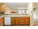 Kitchen features wood cabinets, white appliances, and a mosaic backsplash at 2716 Redland Ln, Indianapolis, IN 46217