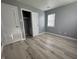 Bright bedroom with grey walls, wood-look floors, and ample closet space at 3305 E 30Th St, Indianapolis, IN 46218