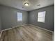 Bedroom with grey walls, wood-look floors, and two windows at 3305 E 30Th St, Indianapolis, IN 46218