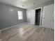 Well-lit bedroom featuring grey walls, wood-look floors, and a closet at 3305 E 30Th St, Indianapolis, IN 46218