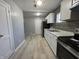 Updated kitchen, featuring white cabinets and gray tile backsplash at 3305 E 30Th St, Indianapolis, IN 46218