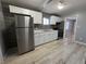 Modern kitchen with white cabinets, gray tile backsplash, and stainless steel appliances at 3305 E 30Th St, Indianapolis, IN 46218
