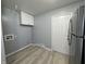Small laundry room with white cabinets and vinyl flooring at 3305 E 30Th St, Indianapolis, IN 46218