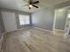 Bright living room with light wood floors and ceiling fan at 3305 E 30Th St, Indianapolis, IN 46218