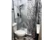 Small bathroom with marble-look shower and gray vanity at 34 Iowa St, Indianapolis, IN 46225
