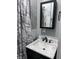 Bathroom with marble vanity, black fixtures, and shower at 34 Iowa St, Indianapolis, IN 46225