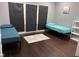Cozy bedroom with two twin beds, dark hardwood floors, and gray window coverings at 34 Iowa St, Indianapolis, IN 46225