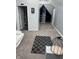 Large bedroom with gray carpeting, a small rug, and access to a bathroom at 34 Iowa St, Indianapolis, IN 46225