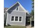 Gray house with white trim, three windows, and a covered porch at 34 Iowa St, Indianapolis, IN 46225