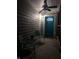 Small front porch with teal door and two chairs at 34 Iowa St, Indianapolis, IN 46225