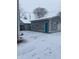 Detached garage with teal door, perfect for additional storage at 34 Iowa St, Indianapolis, IN 46225