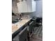 Gray kitchen with granite countertops, white cabinets, and bar seating at 34 Iowa St, Indianapolis, IN 46225