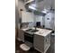 Modern kitchen with gray cabinets, granite countertop island, and stainless steel appliances at 34 Iowa St, Indianapolis, IN 46225