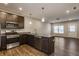 Modern kitchen with island, granite countertops, and stainless steel appliances at 3627 Thomas Jefferson St, Westfield, IN 46074