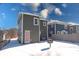 Exterior shot of a house with a small backyard covered in snow, a grey siding, and a pink back door at 4014 N Capitol Ave, Indianapolis, IN 46208