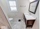 Bathroom featuring tiled floor and walls, updated fixtures, vanity, and natural light at 4014 N Capitol Ave, Indianapolis, IN 46208
