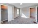 Bedroom featuring gray carpet and paint, a closet with sliding doors, and a window at 4014 N Capitol Ave, Indianapolis, IN 46208