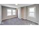 Bedroom featuring gray walls and carpet, baseboard trim, a closet, and a window at 4014 N Capitol Ave, Indianapolis, IN 46208