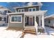 Charming two-story home featuring a covered front porch, gray siding, and a well-maintained lawn at 4014 N Capitol Ave, Indianapolis, IN 46208