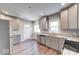 Bright kitchen with stainless steel appliances, granite countertops, and woodgrain flooring at 4014 N Capitol Ave, Indianapolis, IN 46208