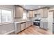 Bright kitchen with stainless steel appliances, granite countertops, and woodgrain flooring at 4014 N Capitol Ave, Indianapolis, IN 46208