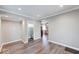 Open-concept living space with hardwood floors, recessed lighting, and access to bathroom and kitchen at 4014 N Capitol Ave, Indianapolis, IN 46208