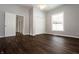 Simple bedroom with dark wood floors and a window at 4870 Parker St, Clayton, IN 46118