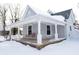 Gray house with a wraparound porch, swing, and snow at 4870 Parker St, Clayton, IN 46118