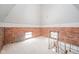Large attic with exposed brick walls and two windows at 503 S Harrison St, Alexandria, IN 46001