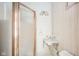 Small bathroom with shower, pedestal sink, and wood-paneled walls at 503 S Harrison St, Alexandria, IN 46001