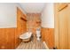 Bathroom with clawfoot tub, toilet, and exposed brick wall at 503 S Harrison St, Alexandria, IN 46001
