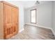 Empty bedroom with hardwood floors, large window, and vintage door at 503 S Harrison St, Alexandria, IN 46001