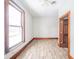 Well-lit bedroom with hardwood floors and an adjacent door at 503 S Harrison St, Alexandria, IN 46001