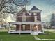 Inviting two-story brick home with a welcoming covered front porch and well-maintained lawn at 503 S Harrison St, Alexandria, IN 46001