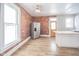 Spacious kitchen with exposed brick wall, stainless steel appliances, and hardwood floors at 503 S Harrison St, Alexandria, IN 46001